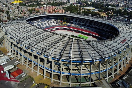 Aerial view of a large circular stadium with a green field and tiered seating.