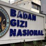 Signboard reading 'Badan Gizi Nasional' with the Indonesian eagle emblem on the left (national nutrition agency).