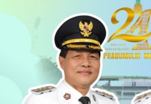Portrait of a man in a white ceremonial uniform and gold-trimmed peaked cap, outlined in white, with a festive backdrop celebrating Prabumulih's 24th anniversary (2001–2025).